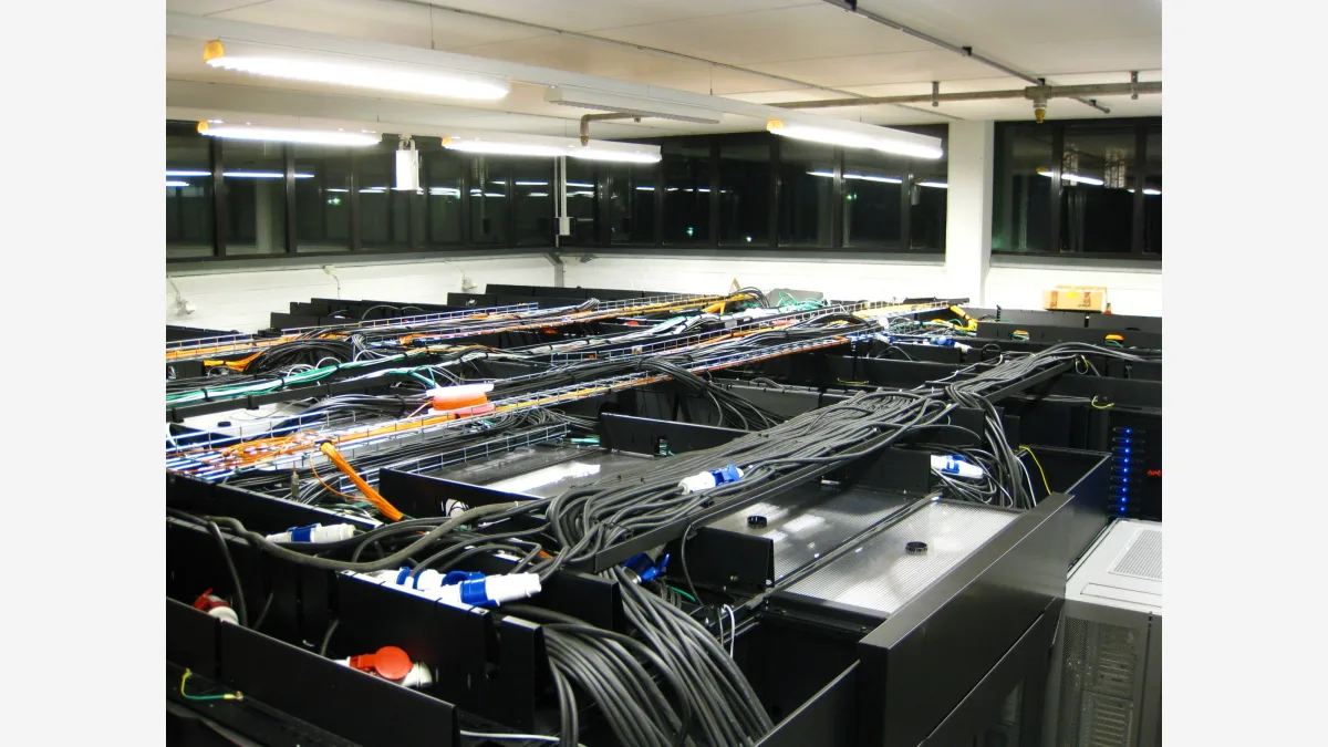 Racks in a server room — Jev's adoption curve is visible only in hosted gateway traffic, which is where agent builders now pick their control-path models.