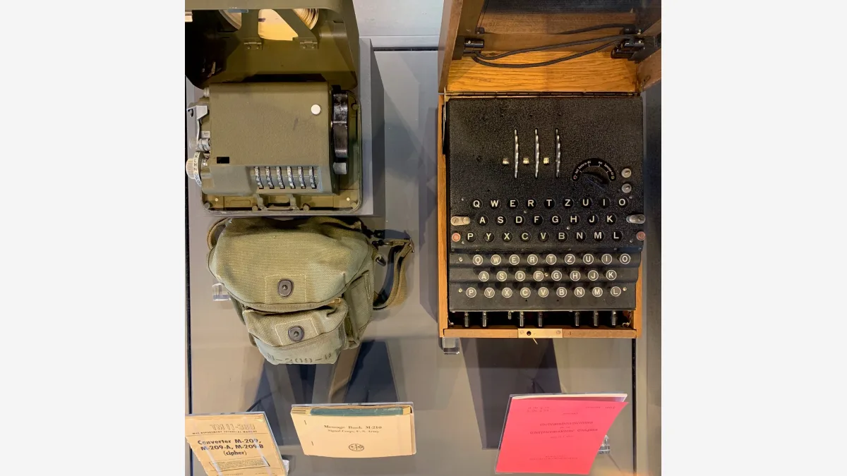 An Enigma cipher machine with its decoding unit on display at the Discovery Park of America; the same machine family produced the MVUEH message GPT-6 Astra broke.