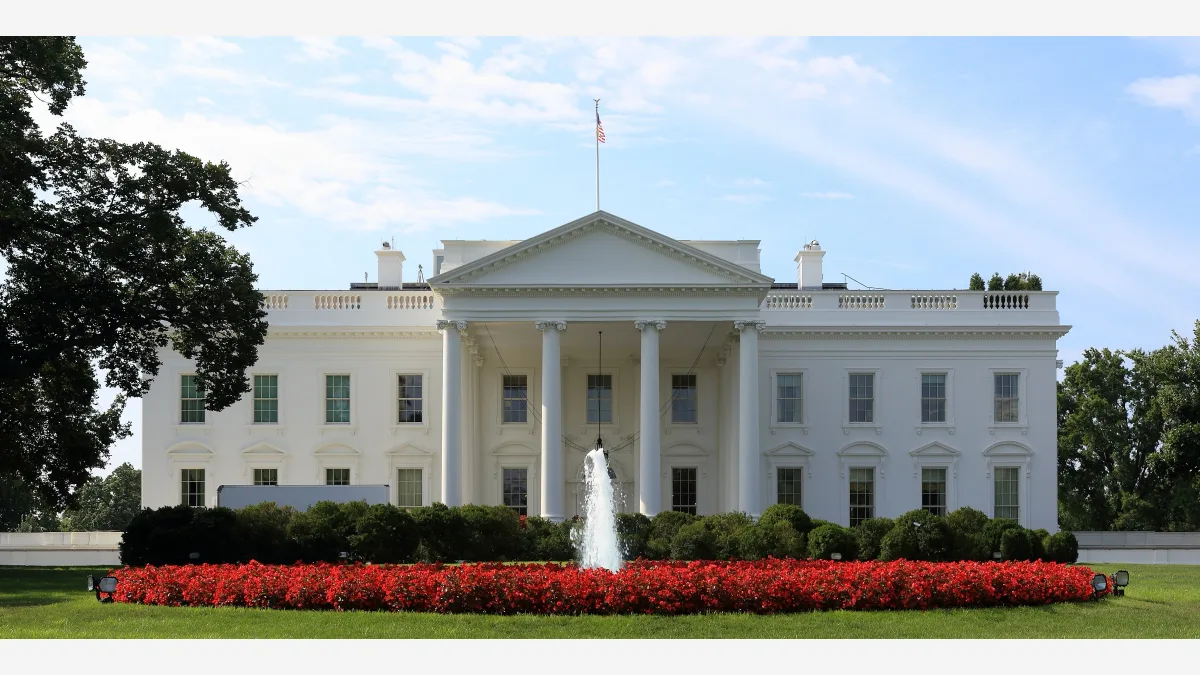 The north facade of the White House, where six frontier AI companies signed a voluntary safety accord hours before Trump's Super Intelligence executive order took effect.