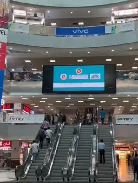 A digital billboard advertising screen — the one-way ad format OpenAI's Sponsored Agents are designed to replace with a two-way conversation.